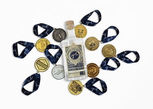 Bottle of T3 Vodka surrounded by decorative award medals on a white background