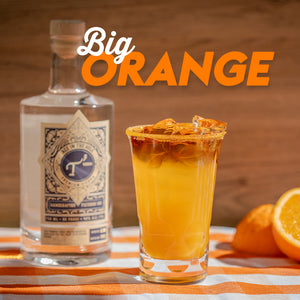 "Big Orange" cocktail with T3 Vodka bottle in an orange-themed table setting